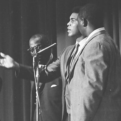 Muhammad Ali speaks to a crowd at the Senate Theater located at 3128 West Madison Street, Chicago, Illinois, during a ceremony to donate items to starving families in Mississippi on July 24, 1967. Photo: ST-50000289-0002, Chicago Sun-Times collection, Chicago History Museum