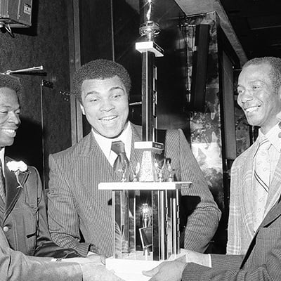 Muhammad Ali is honored by the Woodlawn Chicago Boys Club at the club's 39th annual dinner-dance, hosted by McCormick Inn, East 23rd Street and the Lake, Chicago, Illinois, on October 28, 1977. Photo: T-10003706-0001, Chicago Sun-Times collection, Chicago History Museum
