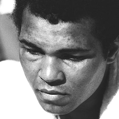 After a shocking loss of the Heavyweight title to Leon Spinks, with swollen eyes Muhammad Ali faces the press conference after the fight. Las Vegas, NV. February 15, 1978. Photo: Courtesy of Michael Gaffney