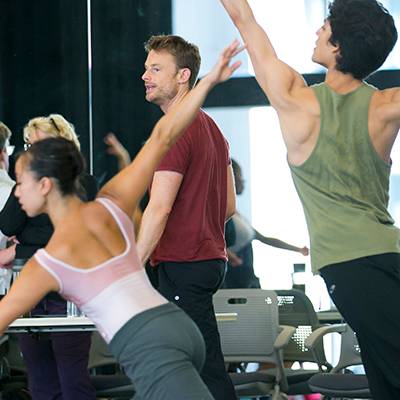 Artistic Director Ashley Wheater and choreographer Christopher Wheeldon (background) and Anastacia Holden¬ and Joan Sebastian Zamora (foreground) in rehearsal (Photo by Todd Rosenberg)