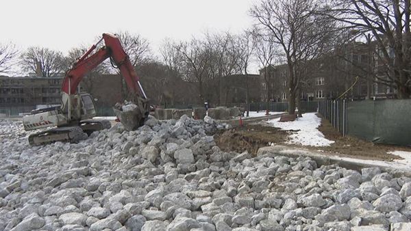 Boulders being placed by construction equipment on the Chicago lakefront.