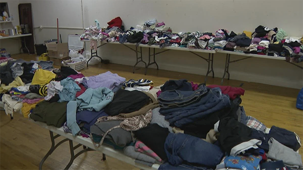 Donated clothes sitting on tables 