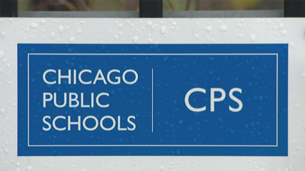 A Chicago Public Schools logo sign covered in rain drops.