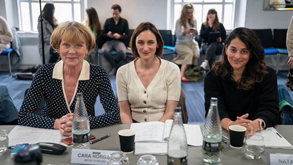 Samantha Bond, Cara Horgan, and Natalie Dew smile for a photo during a table read for The Marlow Murder Club