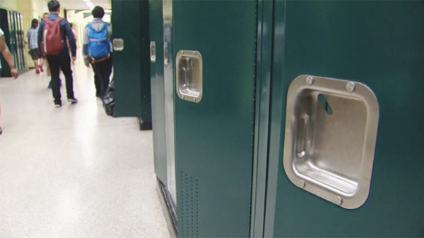 Dark green lockers in a school hallway