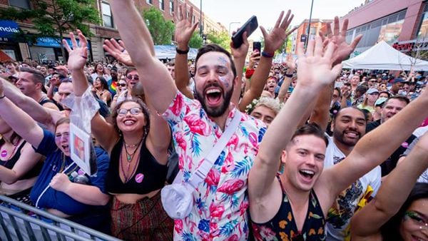 People cheering in a crowd at the 2022 Chicago Pride Festival.