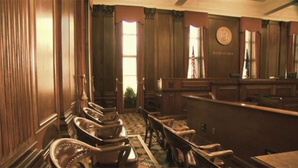 The interior of a wood-paneled courtroom