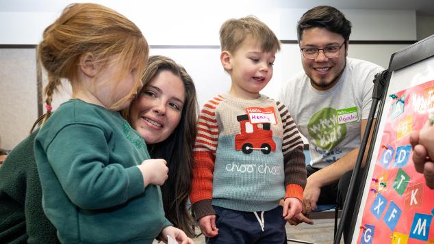 Two toddlers and their parents take part in an activity during WTTW KIds Learn & Play