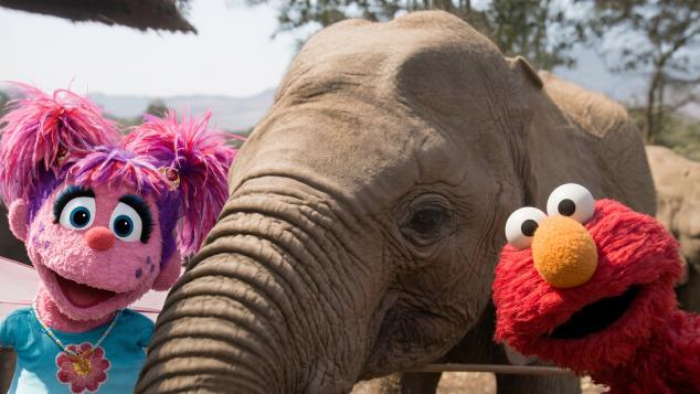 PBS Kids characters Abby and Elmo with an elephant.