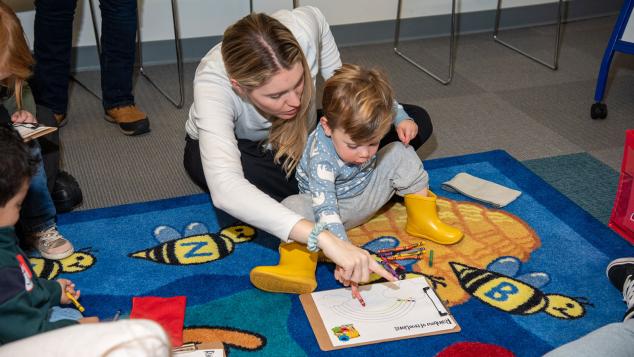 WTTW Kids Learn & Play host engages with a child at a WTTW Kids Learn & Play event.