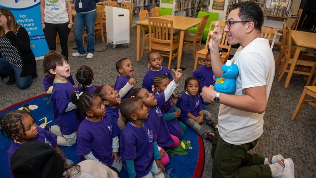 WTTW Kids Learn & Play host Cristian instructs a small group of young children seated before him
