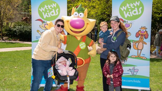 Family of five poses with WTTW Kids' Nature Cat character