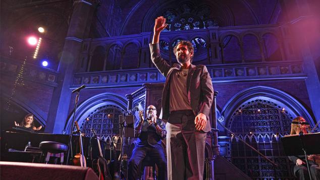 Singer/Songwriter Josh Groban on stage waving to the crowd.
