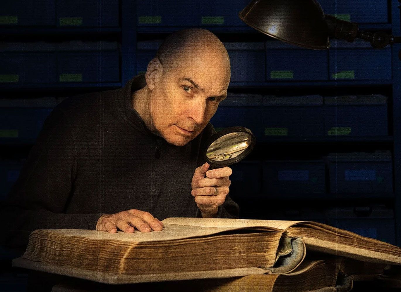 Geoffrey Baer with a magnifying glass.