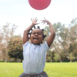 Girl playing with ball.