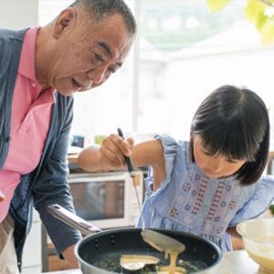 Grandpa and Granddaughter making pancakes.