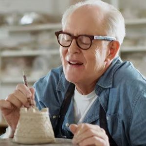 John Lithgow painting pottery.