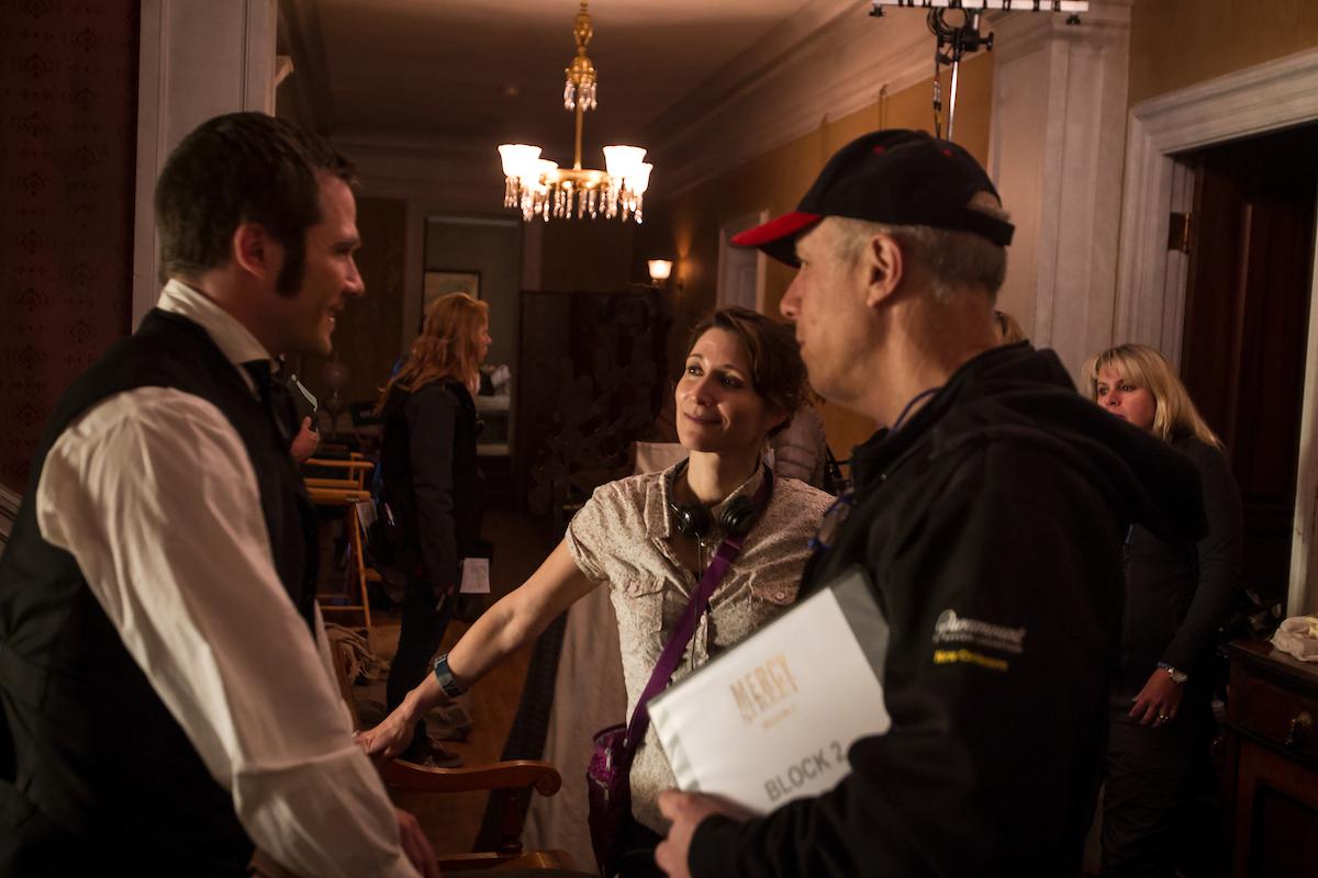 Wolfinger on set speaking to Luke MacFarlane, who plays Chaplain Hopkins. (Courtesy of PBS/Erik Heinila)