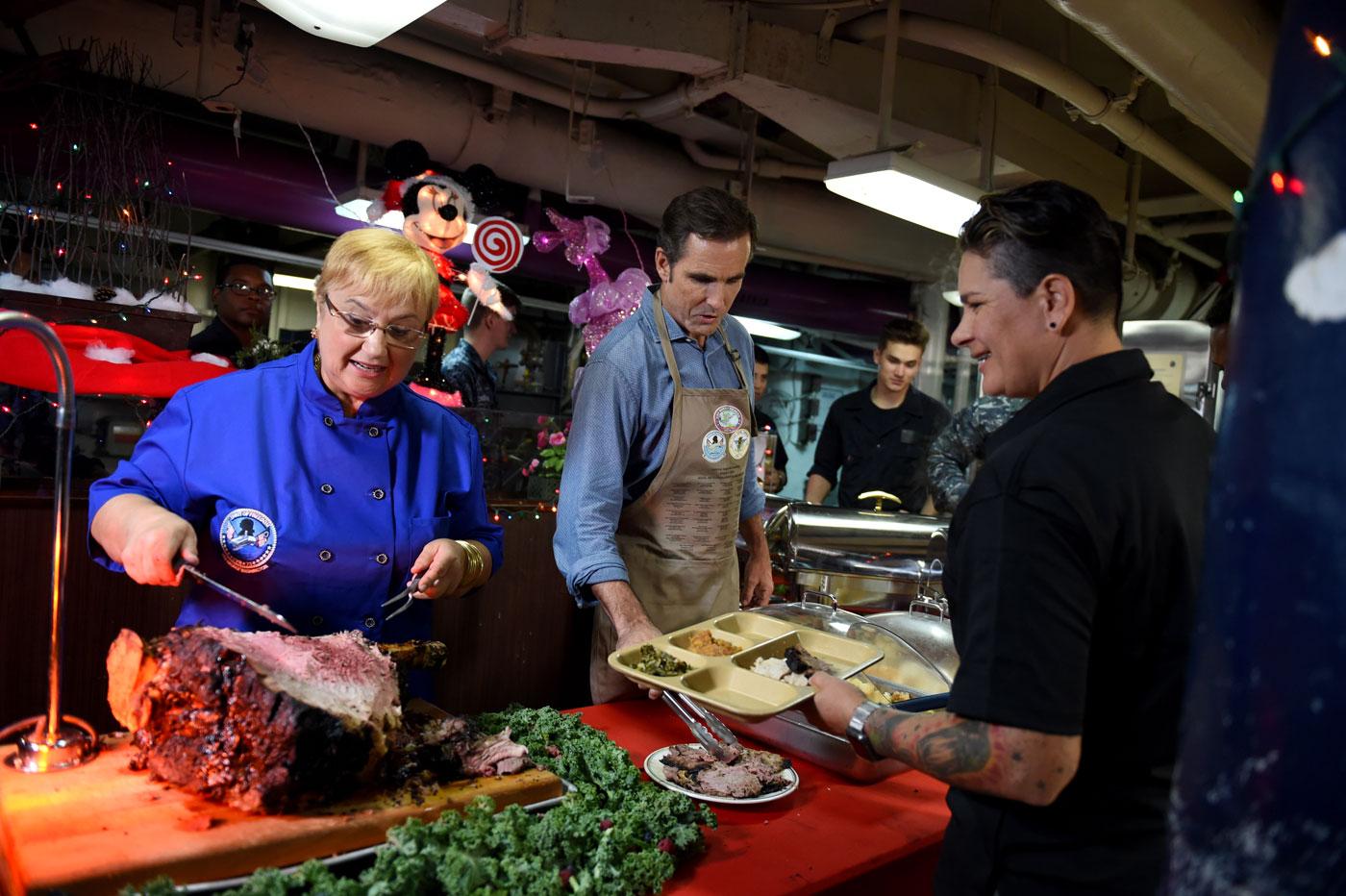 Lidia serves a U.S. Army veteran aboard the USS George Washington. (Courtesy of Meredith Nierman/WGBH)