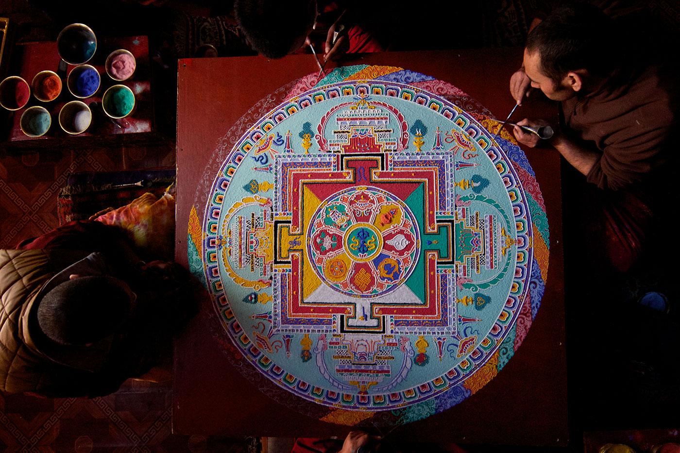 Buddhist monks at Phyang Monastery in Ladakh, India put the finishing touches on a sand Mandala. Photo: BBC/Anthony Pyper