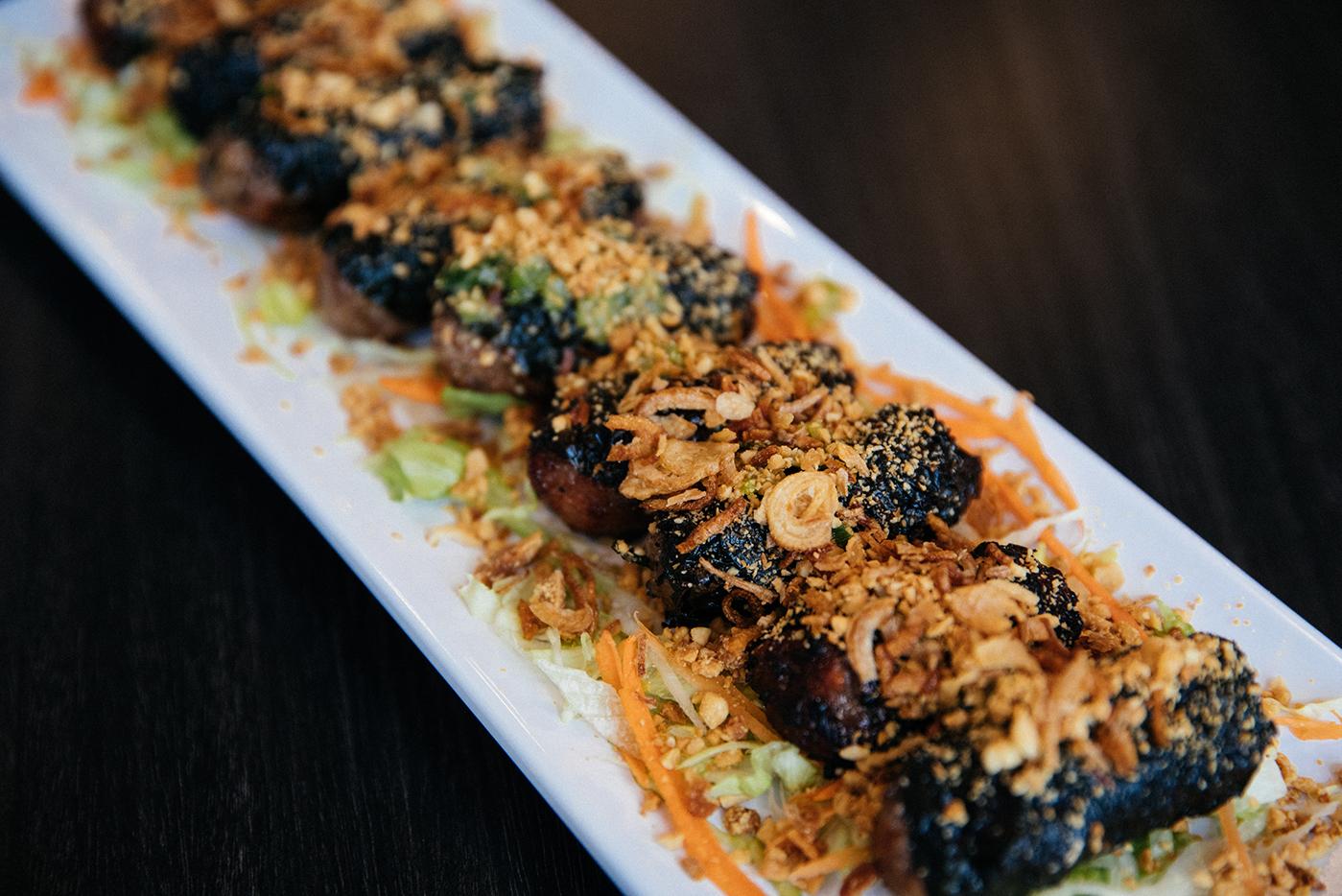 Bò lá lốt (betel leaf-wrapped ground pork and beef) at Chicago's LC Pho n Grill. Photo: Sandy Noto for WTTW