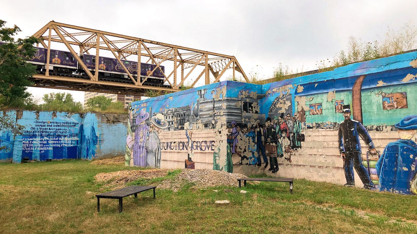 The Green Line passes over a mural noting the previous name of Englewood: Junction Grove. Photo: Brendan Brown