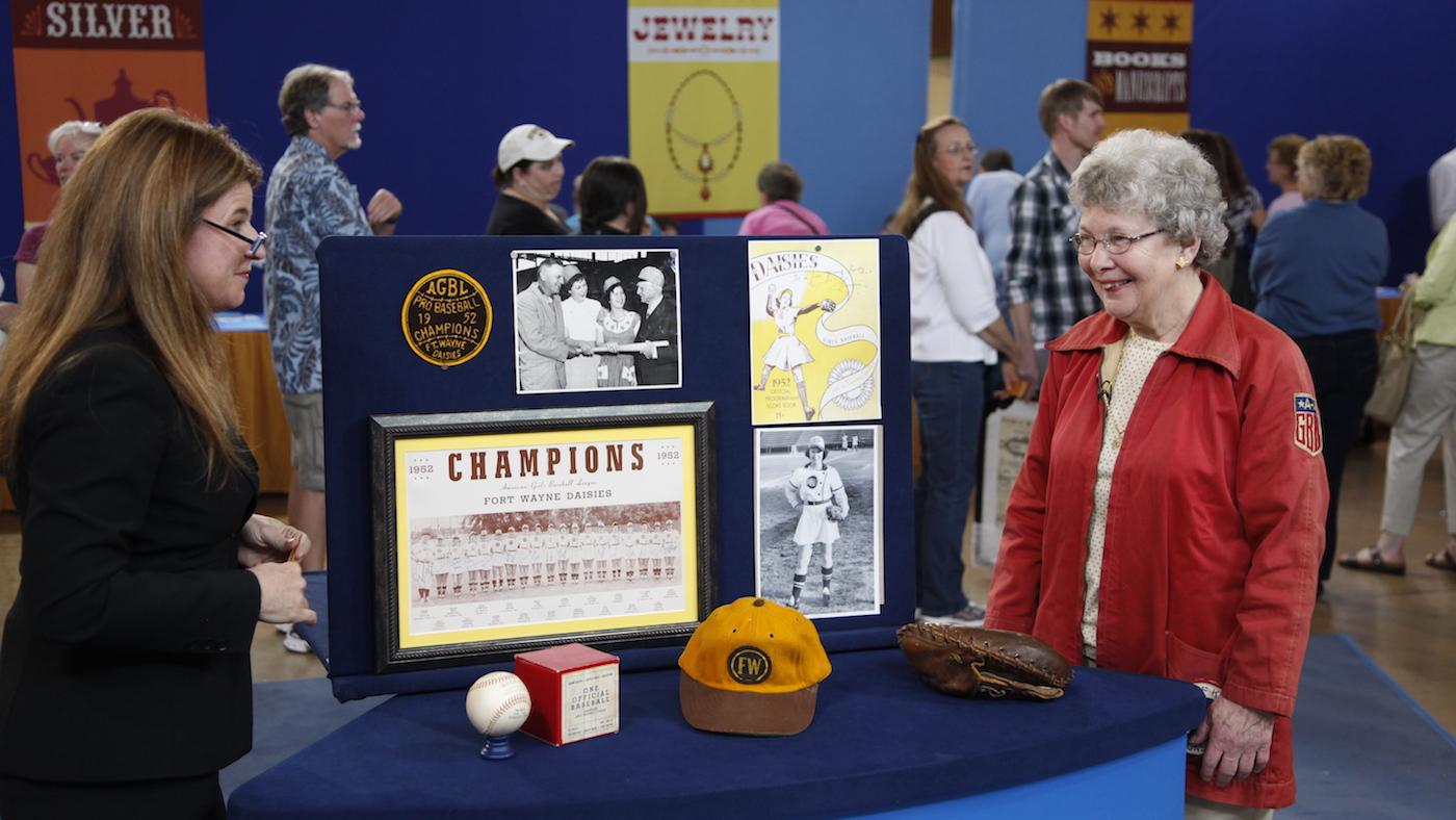 Leila Dunbar (left) appraises a Girls Pro Baseball League collection, ca. 1950, in Eugene, Oregon. Photo: Jeff Dunn for WGBH