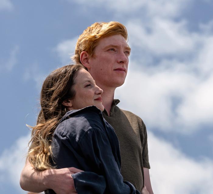 Alice and Jack hug against a blue sky