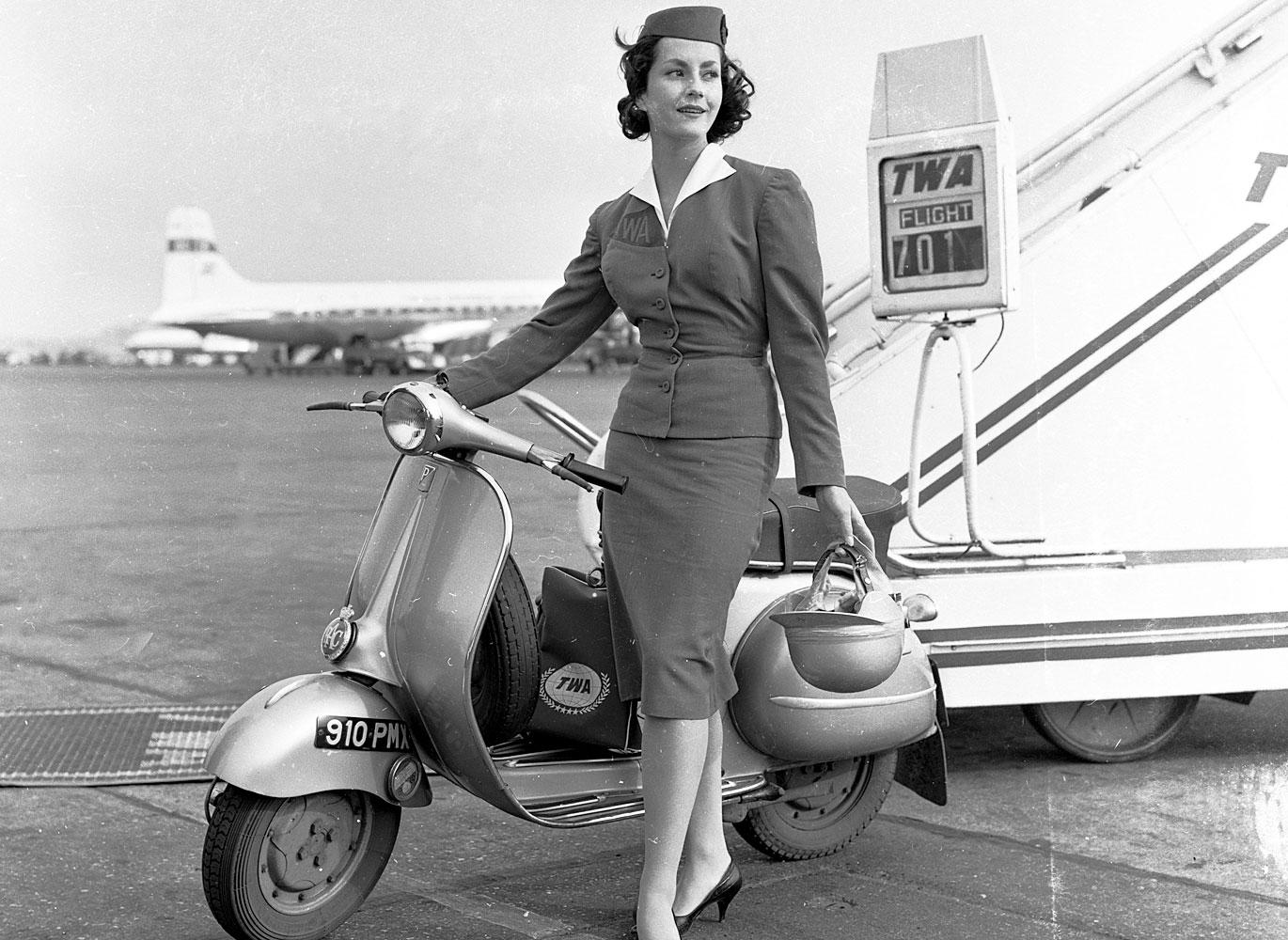 TWA stewardess stands on tarmac, 1955. TWA stewardess stands on tarmac, 1955.