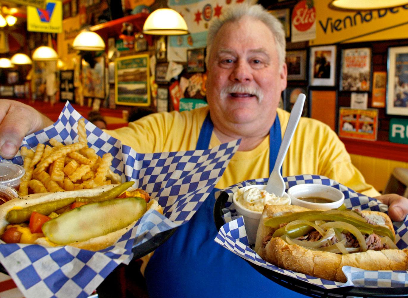 Man serving up hot dog and Italian beef. Man serving up hot dog and Italian beef.