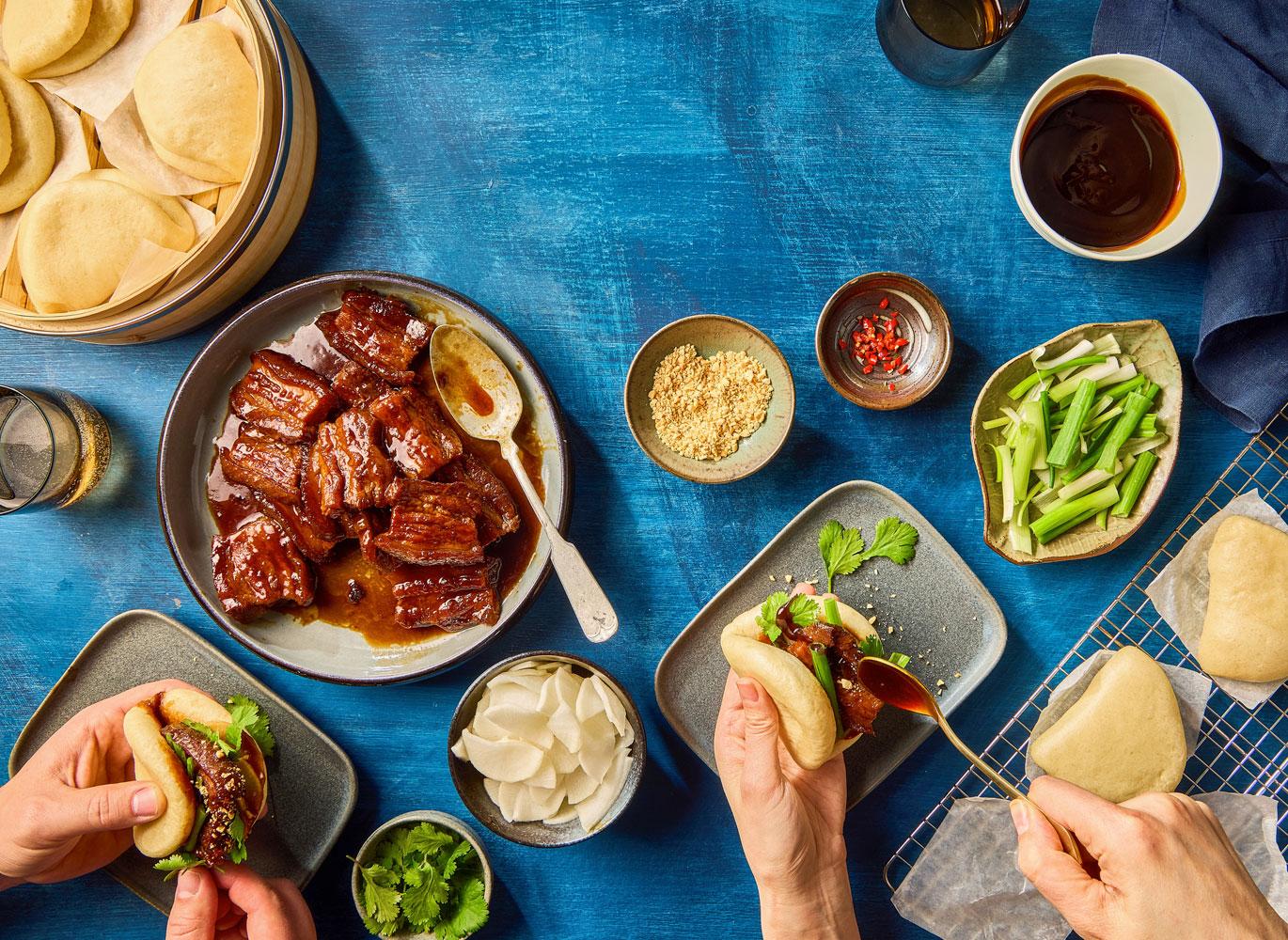 Test cook Dan Souza makes Gua Bao (Taiwanese steamed buns with braised pork belly) for host Julia Collin Davison.