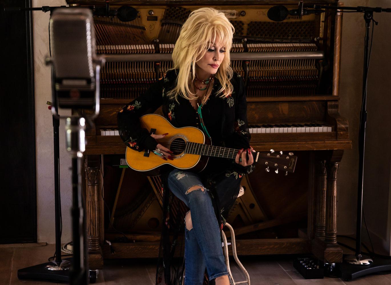 Dolly Parton playing guitar