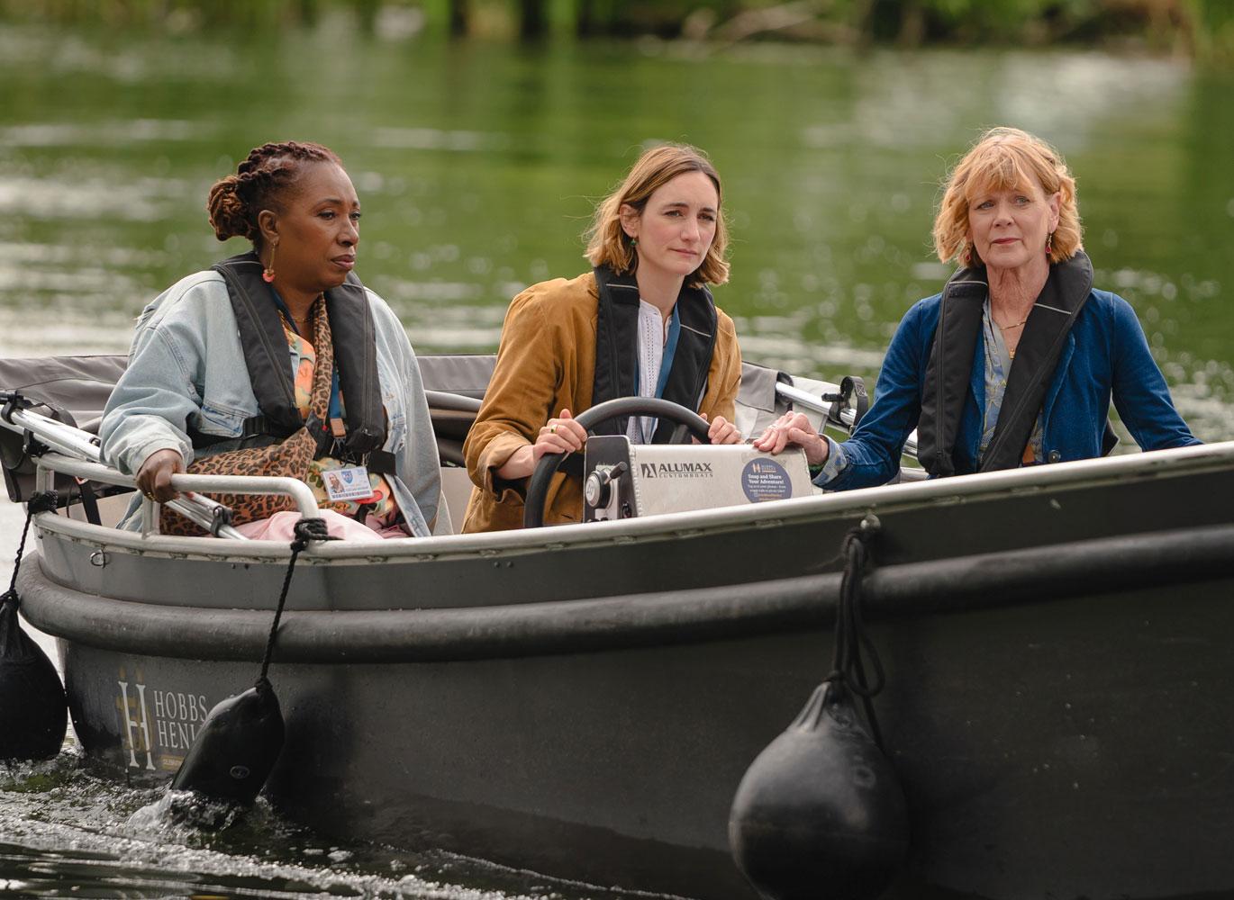 Suzie Harris, Becks Starling, and Judith Potts sitting in a rowboat.