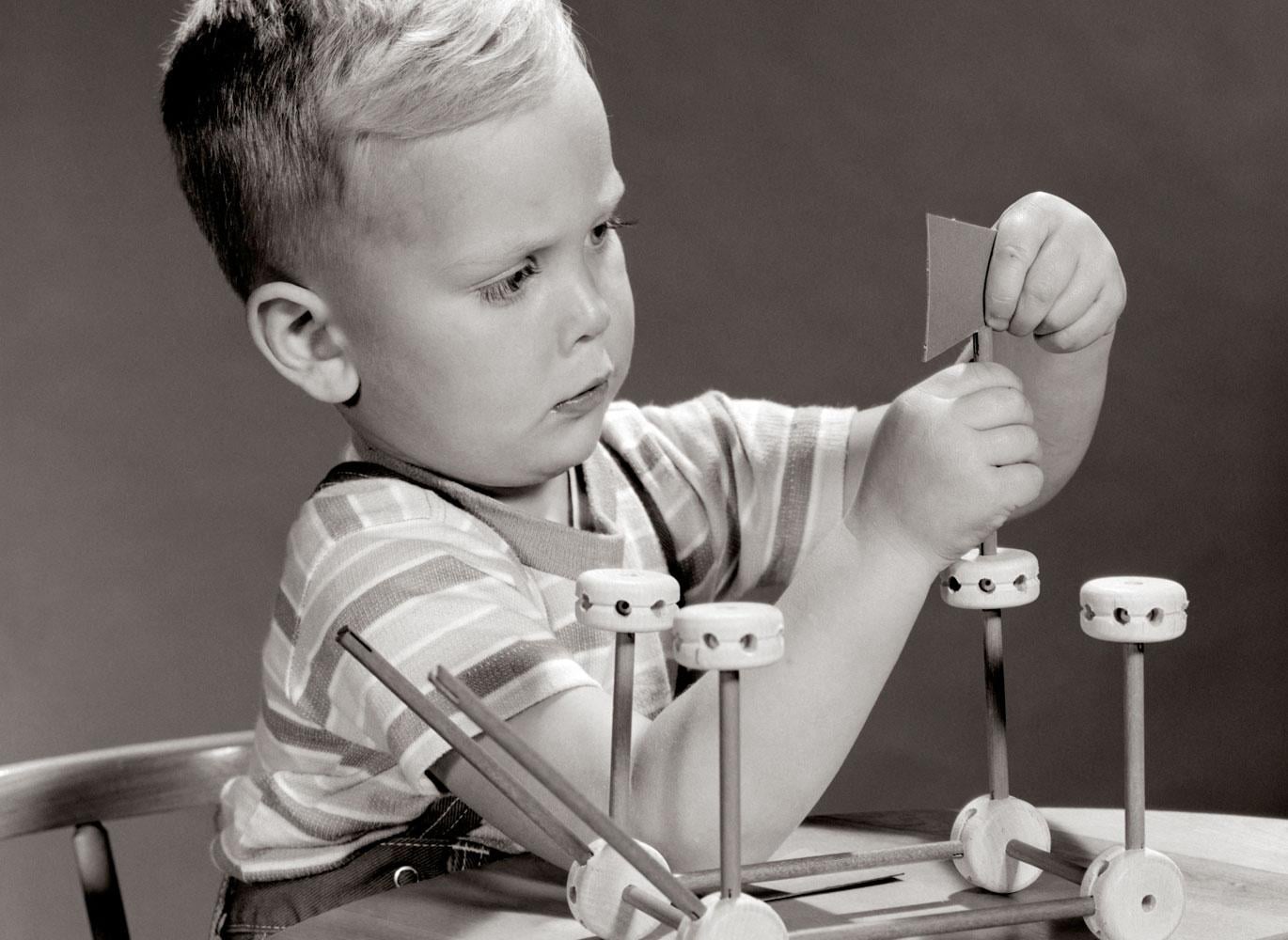Child playing with Tinkertoys