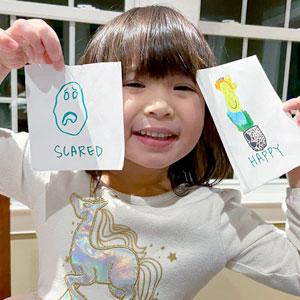 Little girl with her drawings.