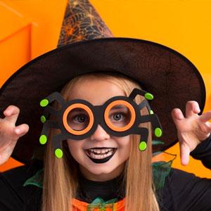 Child acting scary in Halloween costume.