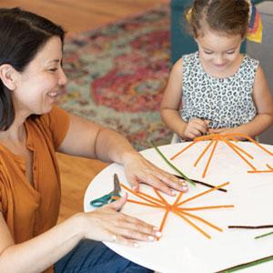 Girl crafting with mom