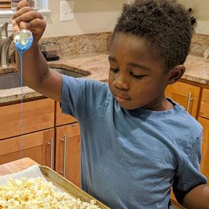 Child making popcorn treat