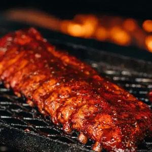 A slab of ribs on the grill