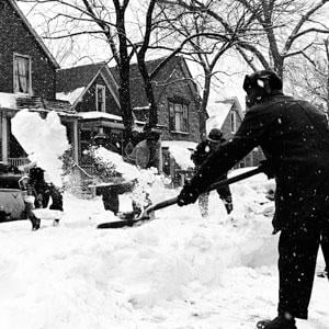 People shoveling during a blizzard.