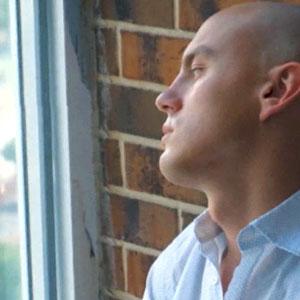 Man looking out window thoughtfully