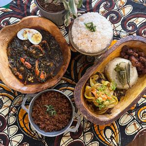 Nimba serves potato greens with shellfish, jollof rice, and attiéké with aloco (plantains) and goat, among other things. Credit: Daniel Hautzinger for WTTW