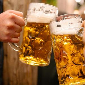 Two beer mugs toasting
