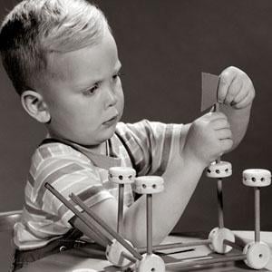 Child playing with Tinkertoys