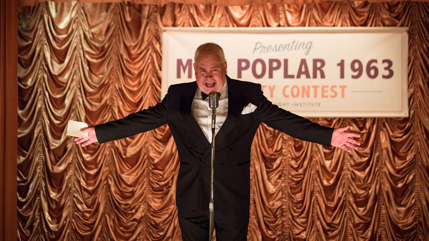 Fred and Violet put on a beauty pageant to raise money for charity, and Valerie decides to enter. Photo: Neal Street Productions 2017 Fred hosting a Miss Poplar beauty pageant in Call the Midwife. Photo: Neal Street Productions 2017