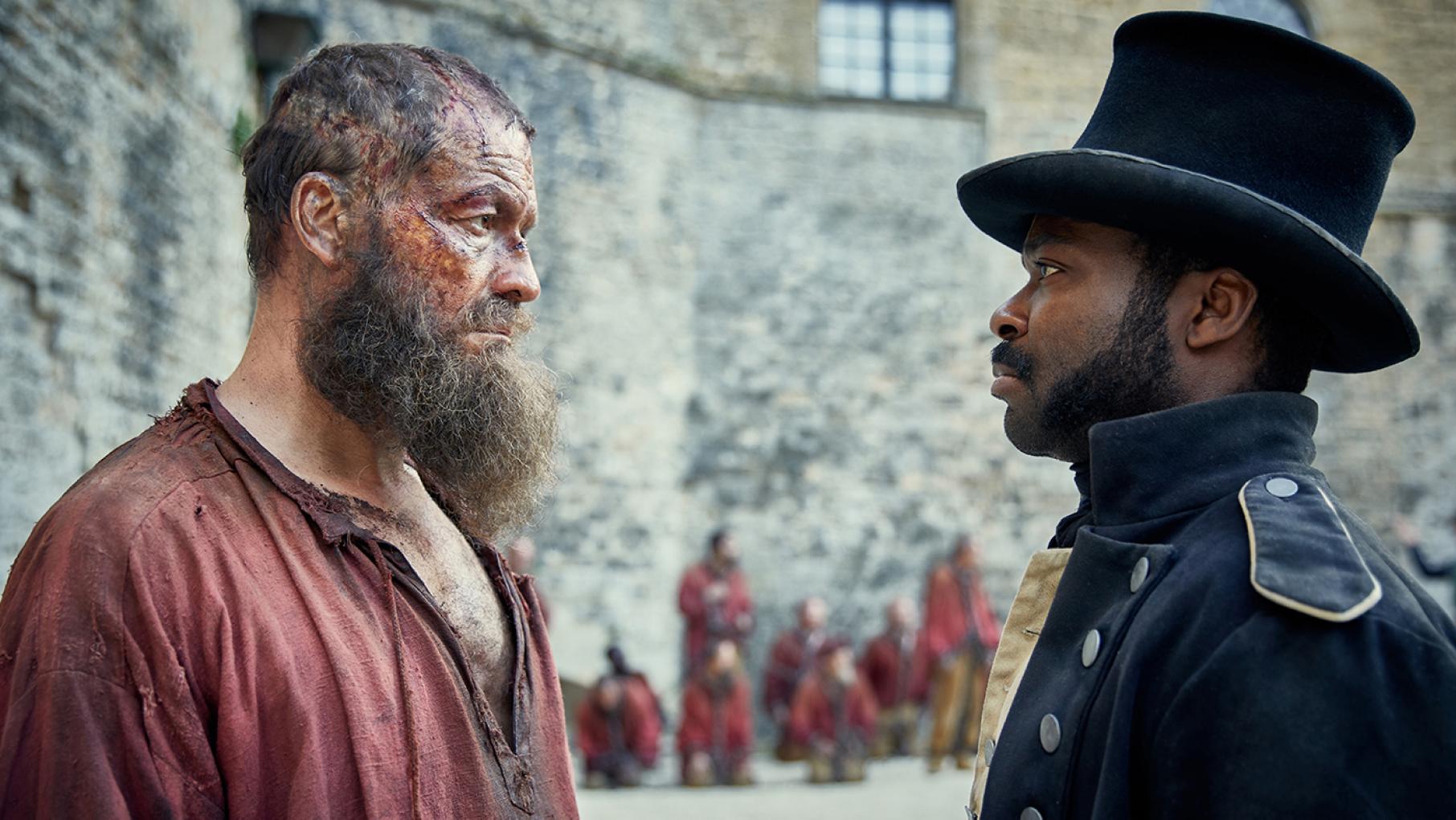 Javert believes prisoner 24601 is a born criminal who will be sent back to prison as soon as he is released. Photo: Robert Viglasky / Lookout Point Jean Valjean (Dominic West) and Javert (David Oyelowo) in Les Miserables. Photo: Robert Viglasky / Lookout Point