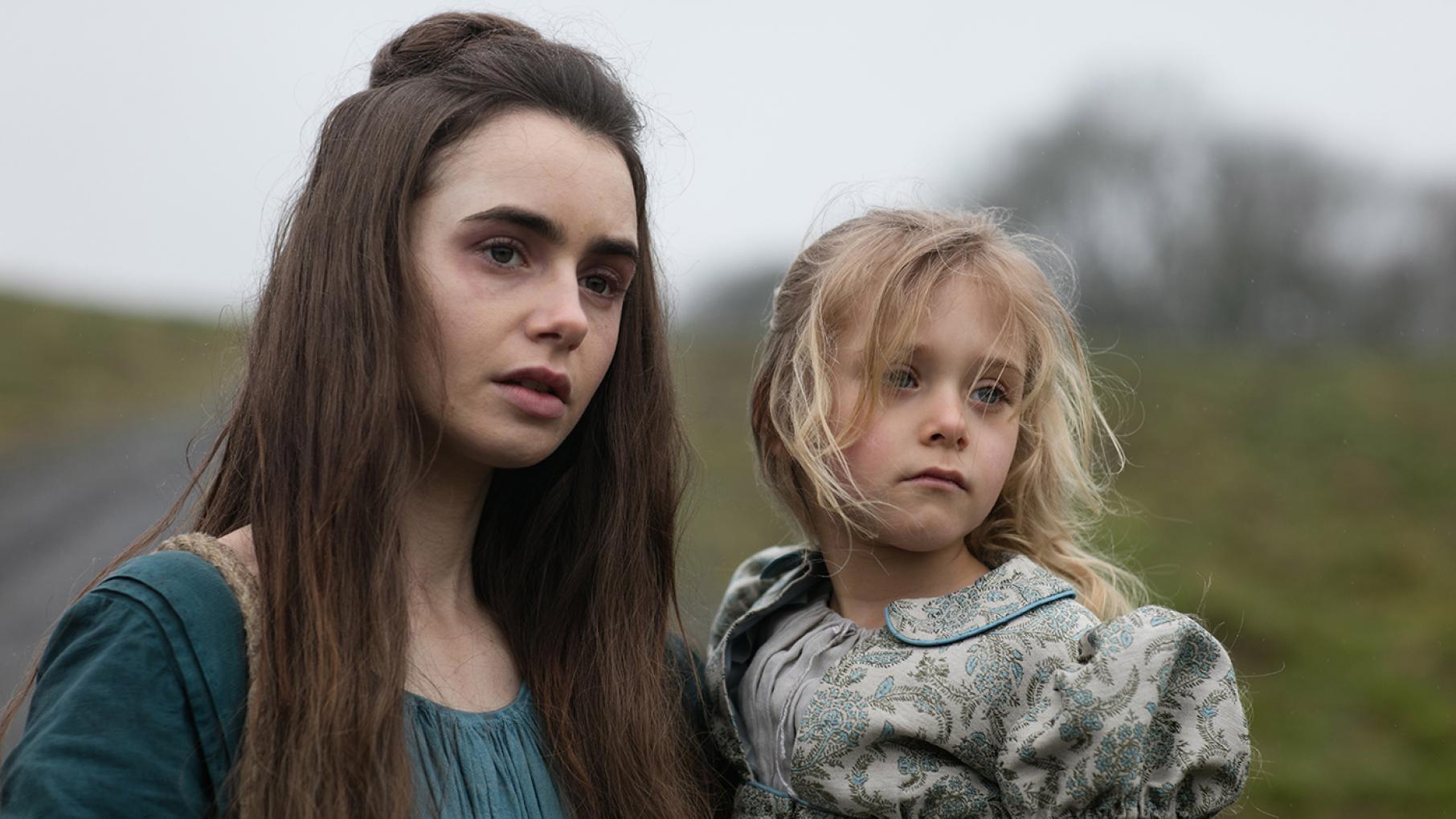 Fantine is struggling to provide for her daughter Cosette, so she leaves Paris to look for work. Photo: Robert Viglasky / Lookout Point Fantine (Lily Collins) and Cosette (Mailow Defoy) in Les Miserables. Photo: Robert Viglasky / Lookout Point