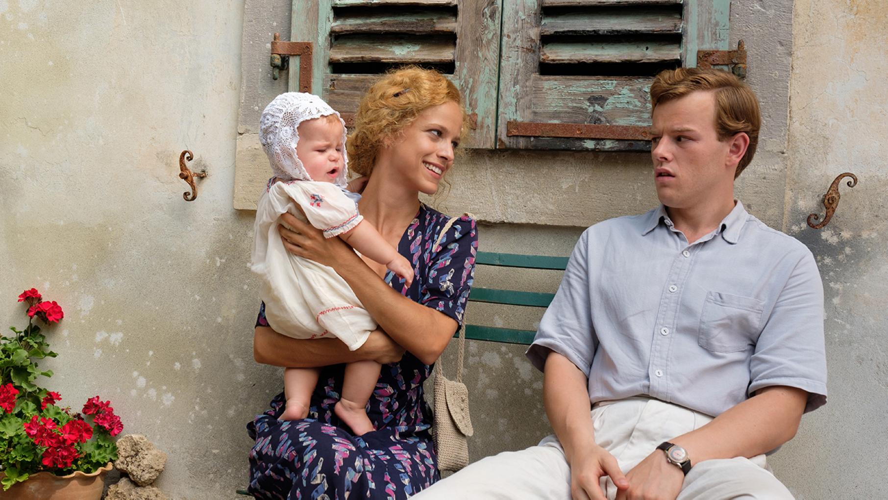 Seeing Daphne with her baby makes Leslie want to start a family of his own. Photo: Sid Gentle Films 2019 Daphne (ELLI TRINGOU) & Leslie Durrell (CALLUM WOODHOUSE) in The Durrells in Corfu. Photo: Sid Gentle Films 2019