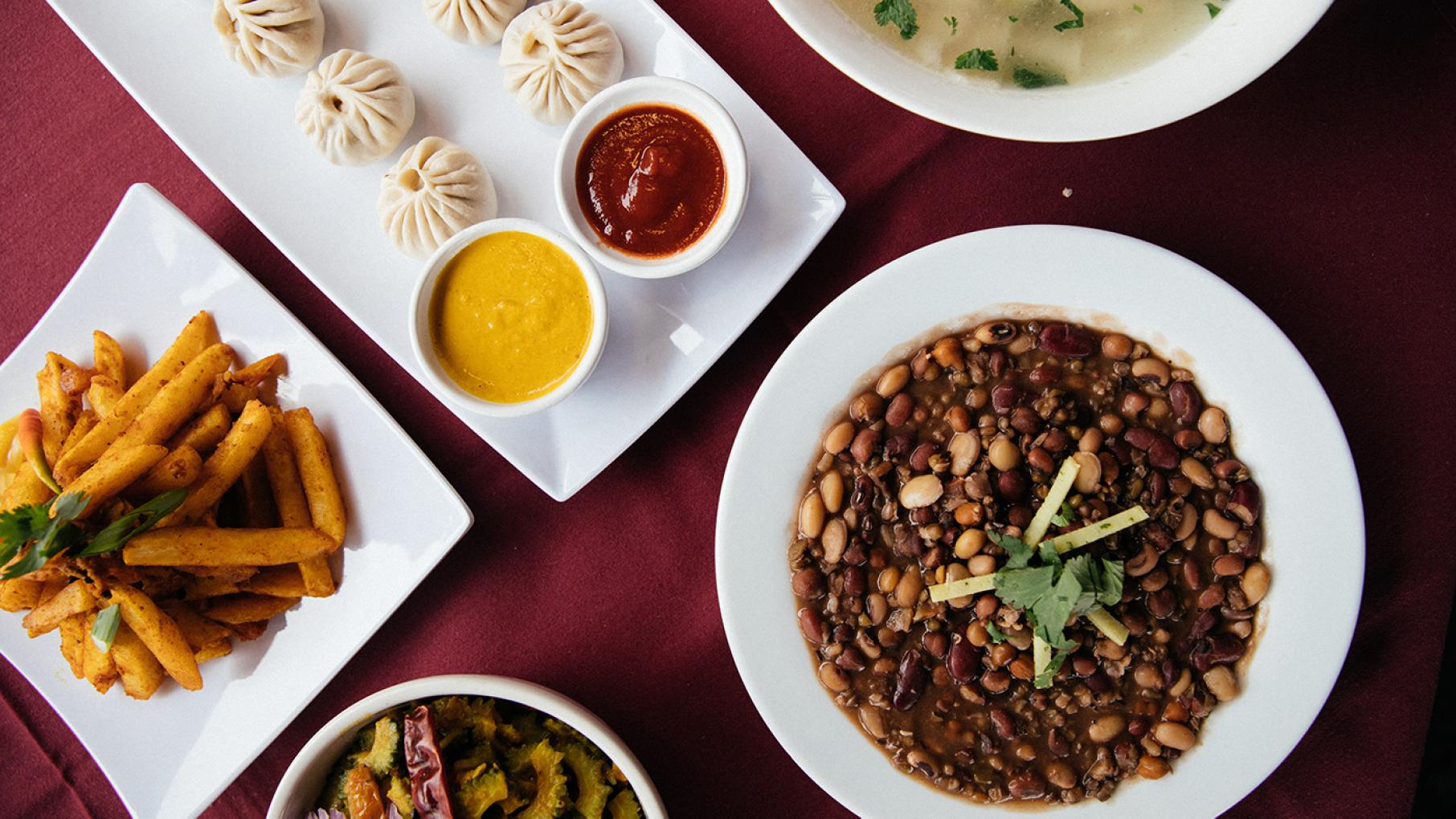 Clockwise from left: base camp potato, momo, thenthuk, kwati, and karela from Himalayan Sherpa Kitchen. Photo: Sandy Noto for WTTW Clockwise from left: base camp potato, momo, thenthuk, kwati, and karela from Himalayan Sherpa Kitchen. Photo: Sandy Noto for WTTW
