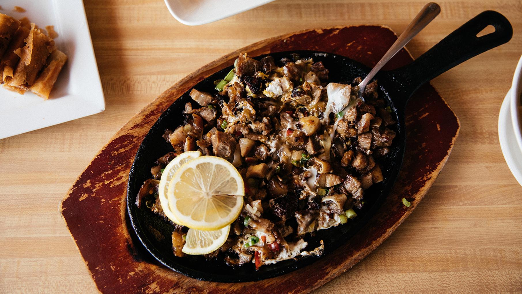 Sisig, a widely loved drinking food consisting of parts of a pig head served in a sizzling-hot cast iron dish with egg mixed in, from Lincoln Square's Isla Pilipina. Photo: Sandy Noto for WTTW Sisig from Isla Pilipina. Photo: Sandy Noto for WTTW